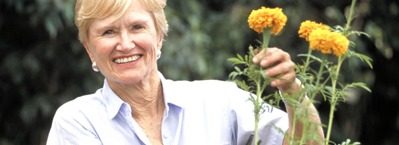 Grandma holding a yellow flower.